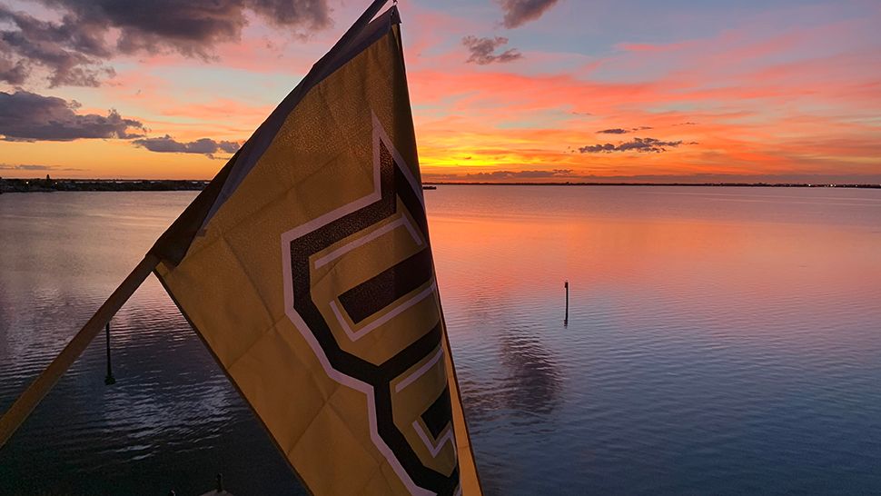 Submitted via the Spectrum News 13 app: A UCF flag on display as the sun sets along the Banana River in Cocoa Beach on Saturday, Nov. 17, 2018. (Courtesy of Michele Parent)