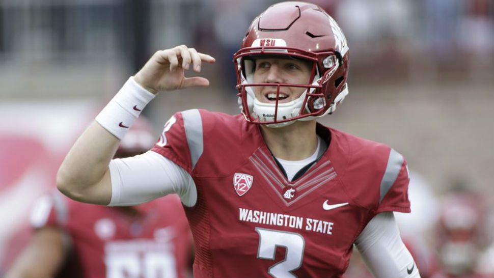 In this Sept. 17, 2016 file photo, Washington State quarterback Tyler Hilinski runs onto the field with his teammates before and NCAA college football game against Idaho in Pullman, Wash. Hilinski has died from an apparent self-inflicted gunshot wound. The 21-year-old Hilinski was discovered in his apartment after he didn't show up for practice Tuesday Jan. 16 2018. (AP Photo/Young Kwak, file)