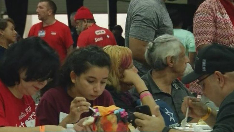 H-E-B Feast of Sharing participants enjoying a meal. (Spectrum News footage)