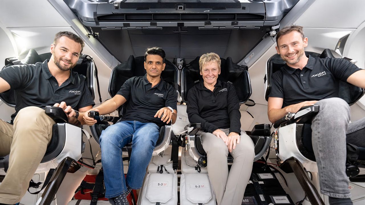 From left, Ax-4 Mission specialist Tibor Kapu, pilot Shubhanshu Shukla, Cmdr. Peggy Whitson, and mission specialist Sławosz Uznański are sitting in a SpaceX Dragon spacecraft. (SpaceX)