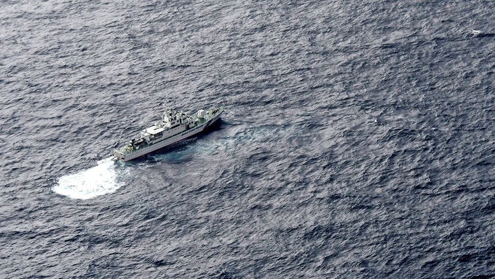 In this aerial photo, Japan's Coast Guard ship is seen at sea during a search operation for U.S. Marine refueling plane and fighter jet off Muroto, Kochi prefecture, southwestern Japan, Thursday, December 6, 2018. (Kyodo News via AP)