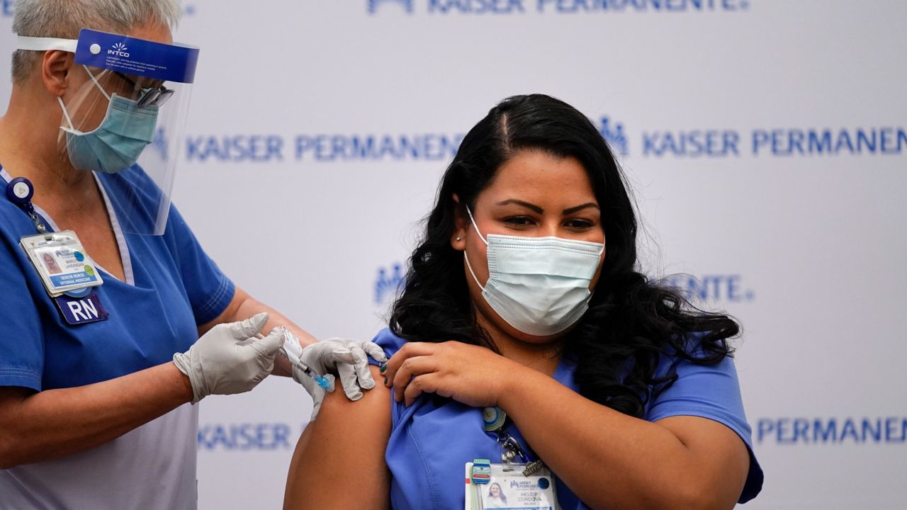 Health care workers receive the COVID-19 vaccine (AP Image/File)