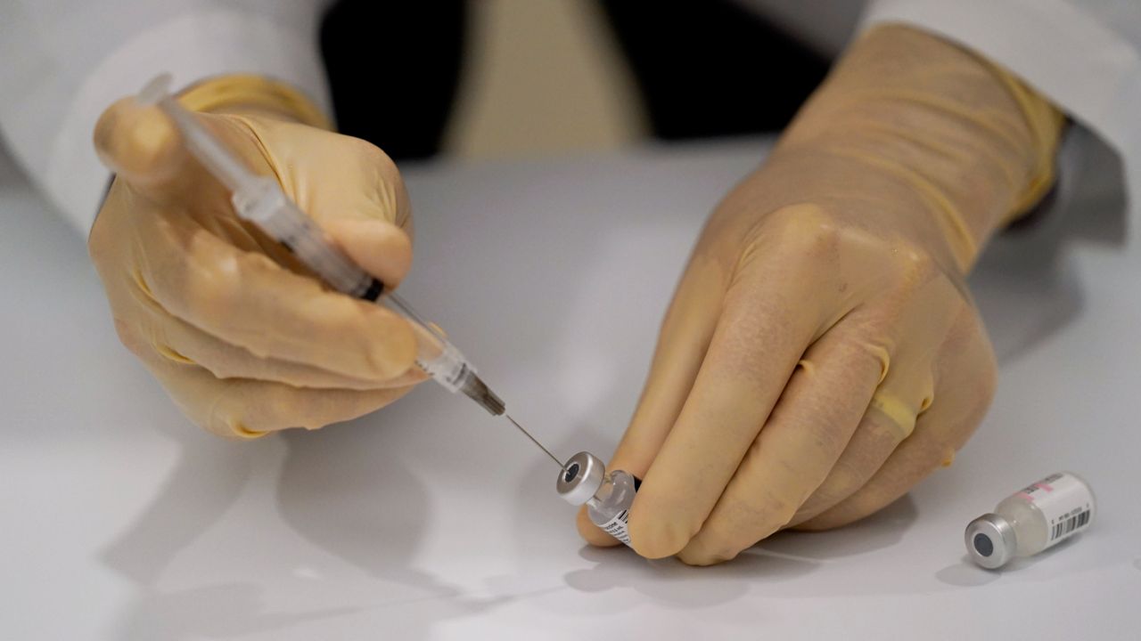 The Pfizer-BioNTech COVID-19 vaccine being prepared at Kaiser Permanente Los Angeles Medical Center on Monday, Dec. 14, 2020. (AP Photo/Jae C. Hong)