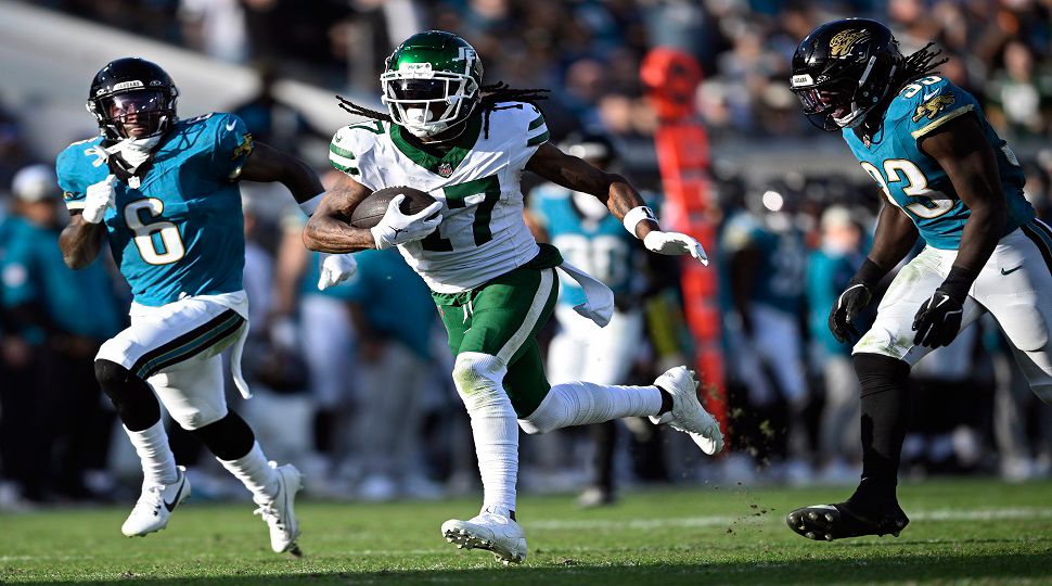 New York Jets wide receiver Davante Adams (17) gets between Jacksonville Jaguars safety Darnell Savage (6) and linebacker Devin Lloyd (33) to score on a 71-yard touchdown reception during the second half of an NFL football game Sunday, Dec. 15, 2024, in Jacksonville, Fla. (AP Photo/Phelan M. Ebenhack)