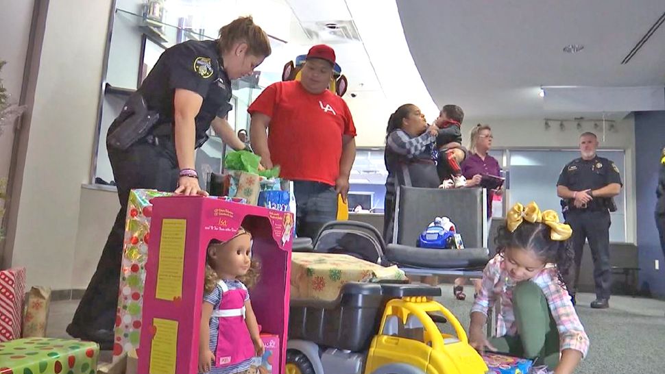 Mount Dora Police Community Relations Officer Ivy Severance along with the rest of the department got the family Christmas gifts to alleviate some of the stress and put a smile on the children's faces because this time of year is extremely difficult for them. (Spectrum News 13)