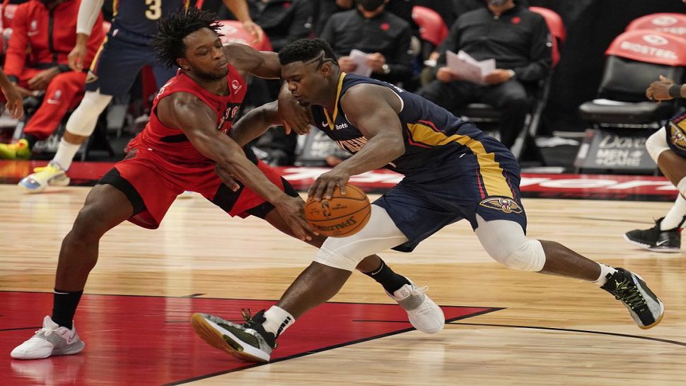 Toronto Raptors forward OG Anunoby (3) knocks the ball away from 2019 No. 1 overall pick Zion Williamson during the second half of Toronto's 113-99 loss to New Orleans.  (AP Photo/Chris O'Meara)