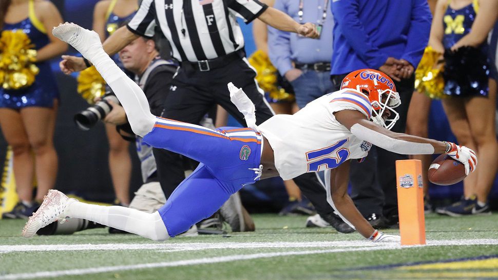 Florida wide receiver Van Jefferson dives for the end zone and comes up just short.  The Gators settled for a field goal on this drive, but it was one of the few disappointments for Florida, as they routed Michigan 41-15 in the Chick-fil-A Peach Bowl.  (AP Photo/John Bazmore)