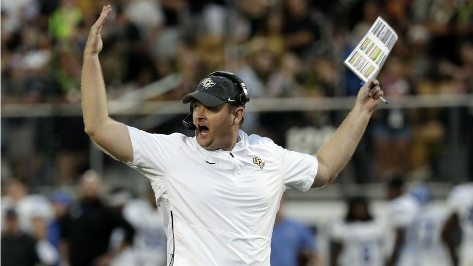 FILE - In this Dec. 1, 2018, file photo, Central Florida head coach Josh Heupel waves his arms during the first half of the American Athletic Conference championship NCAA college football game against Memphis, in Orlando, Fla. Heupel, Notre Dame’s Brian Kelly and Alabama’s Nick Saban are the finalists for The Associated Press national college football coach of the year after leading their teams to unbeaten regular seasons. The winner will be announced Monday, Dec. 17. (AP Photo/John Raoux, File)
