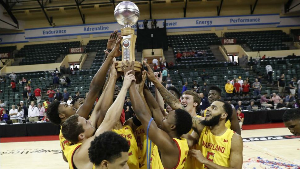 Maryland players celebrate with the Orlando Invitational Trophy after defeating Marquette during an NCAA college basketball game Sunday, Dec. 1, 2019, in Lake Buena Vista, Fla. (AP Photo/Scott Audette)