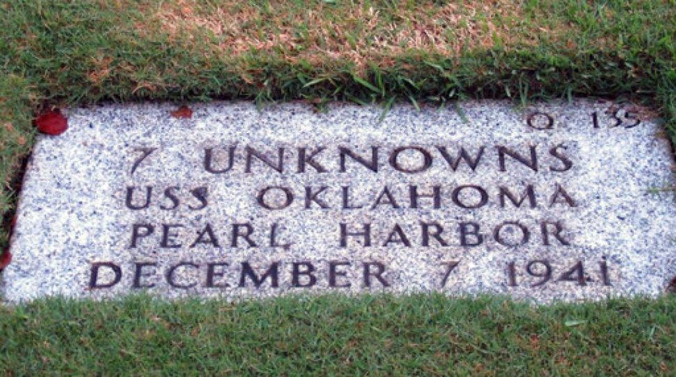A gravestone identifying the resting place of 7 unknowns from the USS Oklahoma is shown at the National Memorial Cemetery of the Pacific in Honolulu. (AP Photo/Audrey McAvoy, File)