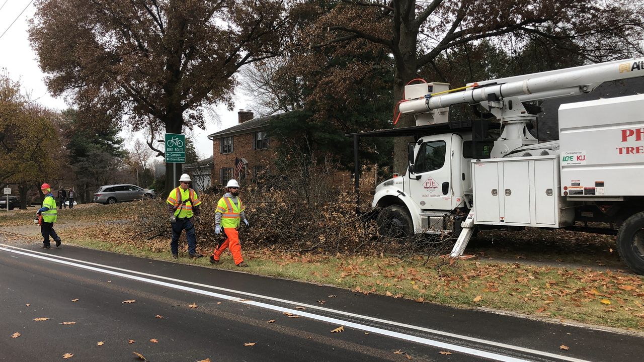 A team of Kentucky Utility workers trim trees on Lansdowne Drive neighborhood. (Spectrum News 1/Khyati Patel)