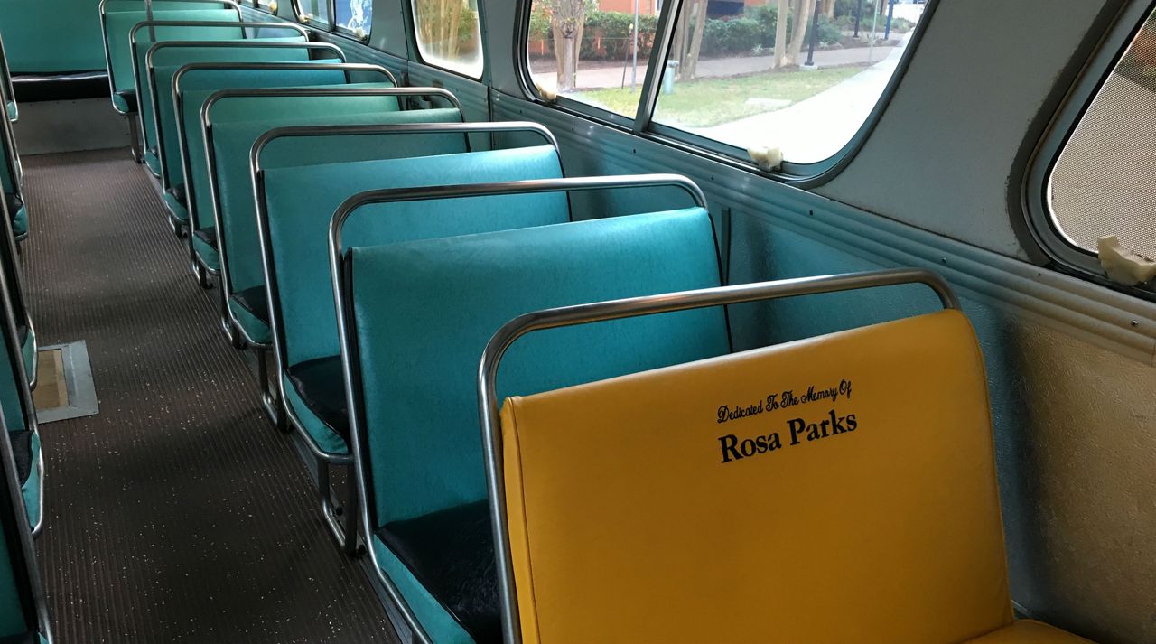 A yellow set dedicated to honoring Rosa Parks inside of a VIA bus from the Civil Rights movement era (Spectrum News/File)