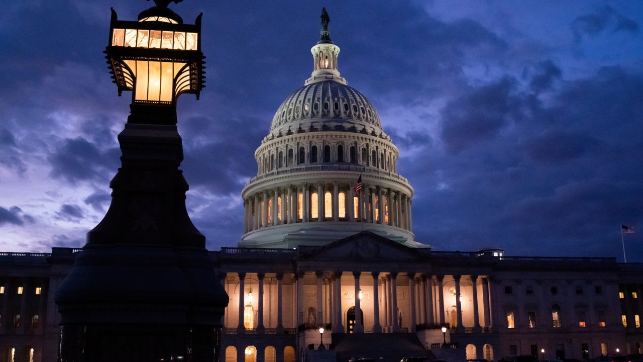 Night falls at the Capitol in Washington, Thursday, Dec. 2, 2021, with the deadline to fund the government approaching. (AP Photo/J. Scott Applewhite)