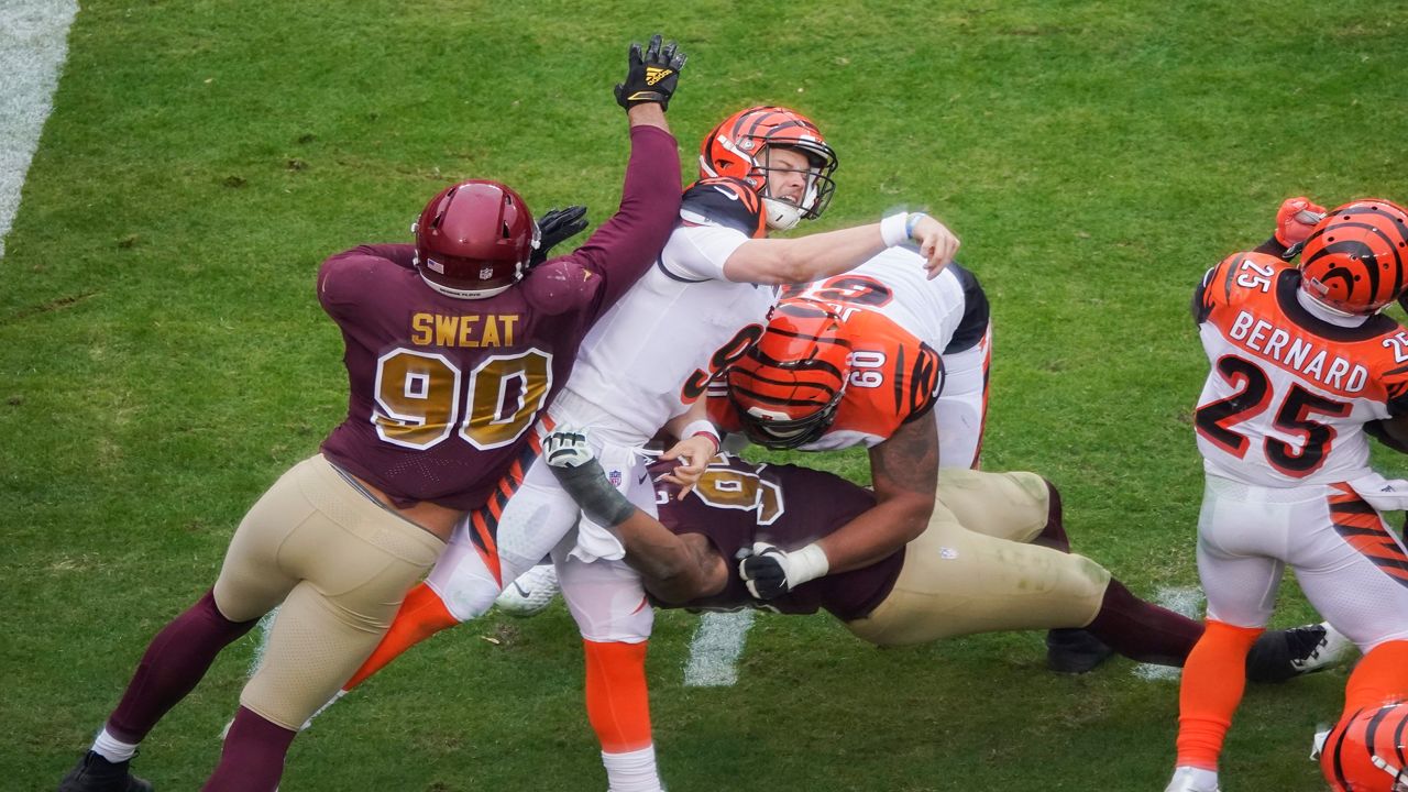 Joe Burrow is hit by two players while throwing