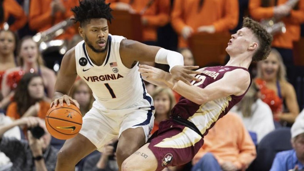 Virginia's Jayden Gardner (1) commits a foul against Florida State's Tom House. (AP Photo/Mike Kropf)