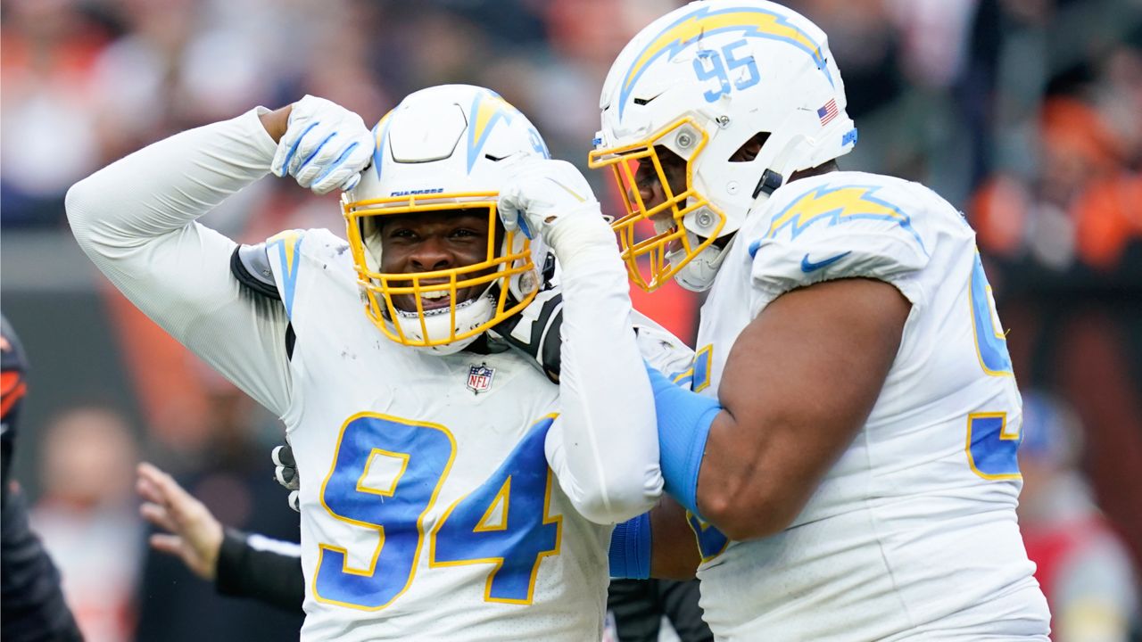 Los Angeles Chargers' Chris Rumph II (94) and Christian Covington (95) celebrate a play during the second half of an NFL football game against the Cincinnati Bengals, Sunday, Dec. 5, 2021, in Cincinnati. (AP Photo/Michael Conroy)