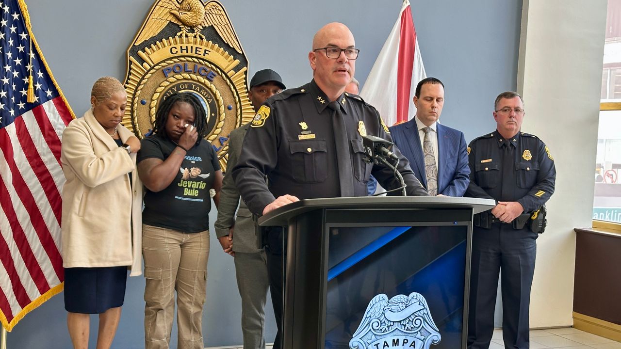 With family members of Jevario Buie behind him, Tampa Police Chief Lee Bercaw announces the arrest of Jahmir Moore. (Spectrum Bay News 9/Matt Infante)