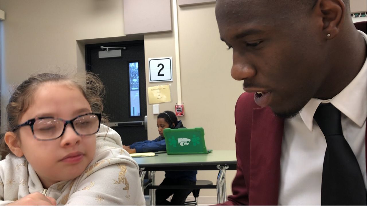 Jaylen Brown with a student
