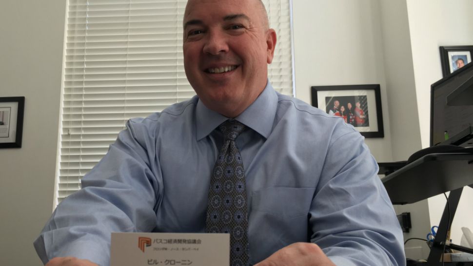 Pasco Economic Development Council President & CEO Bill Cronin displays a business card written in Japanese at his office in Lutz. (Sarah Blazonis/Spectrum Bay News 9)