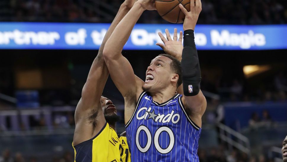 Orlando Magic's Aaron Gordon (00) goes up for a shot against Indiana Pacers' Thaddeus Young during the second half of an NBA basketball game Friday, Dec. 7, 2018, in Orlando, Fla. (AP Photo/John Raoux)