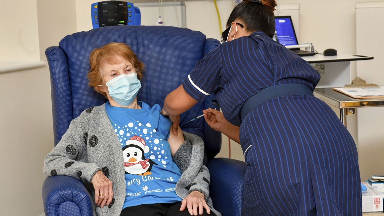 90-year-old Margaret Keenan, the first patient in the UK to receive the Pfizer-BioNTech COVID-19 vaccine, administered by nurse May Parsons at University Hospital, Coventry, England, Tuesday Dec. 8, 2020. (Jacob King/Pool via AP)