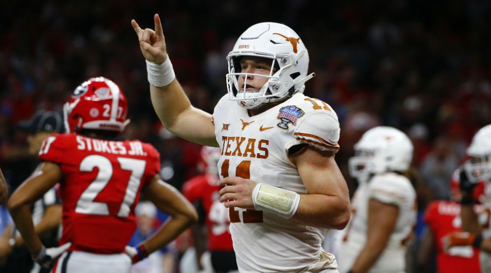 In this Tuesday, January 1, 2019 file photo, Texas quarterback Sam Ehlinger (11) celebrates his second touchdown carry in the first half of the Sugar Bowl NCAA college football game against Georgia in New Orleans. (AP Photo/Butch Dill, File)