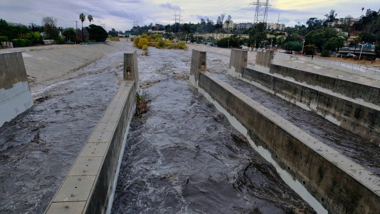 Rushing rainwater fills the Los Angeles river near downtown Los Angeles on Dec. 9, 2018. (AP Photo/Richard Vogel)