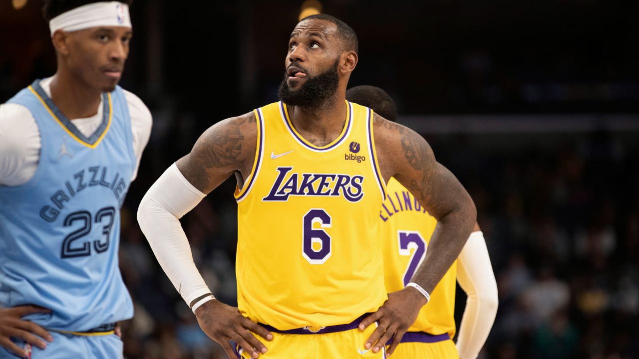 Los Angeles Lakers forward LeBron James waits next to Memphis Grizzlies guard Jarrett Culver (23) for the second half of the NBA basketball game to resume Thursday, Dec. 9, 2021, in Memphis, Tenn. (AP Photo/Nikki Boertman)