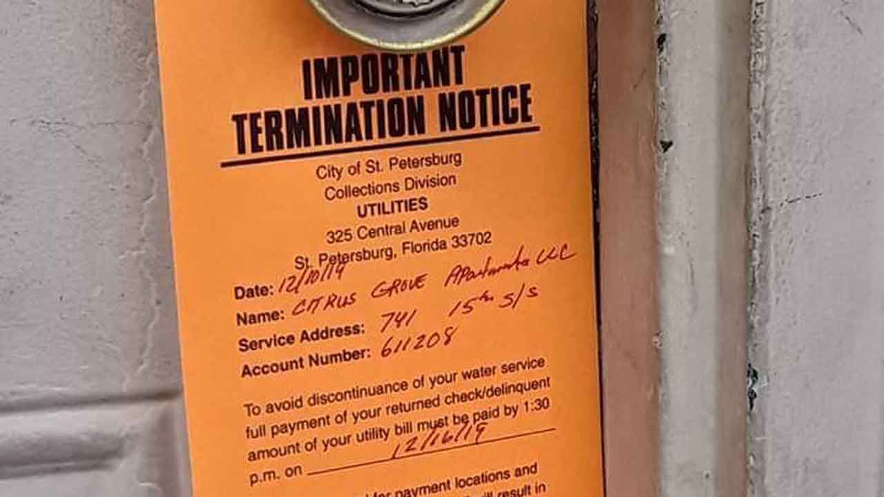 Utilities service termination notices went on the doors of residents at the Citrus Grove Apartments this week, threatening to shut off water to the community due to an unpaid bill. (Trevor Pettiford/Spectrum Bay News 9)