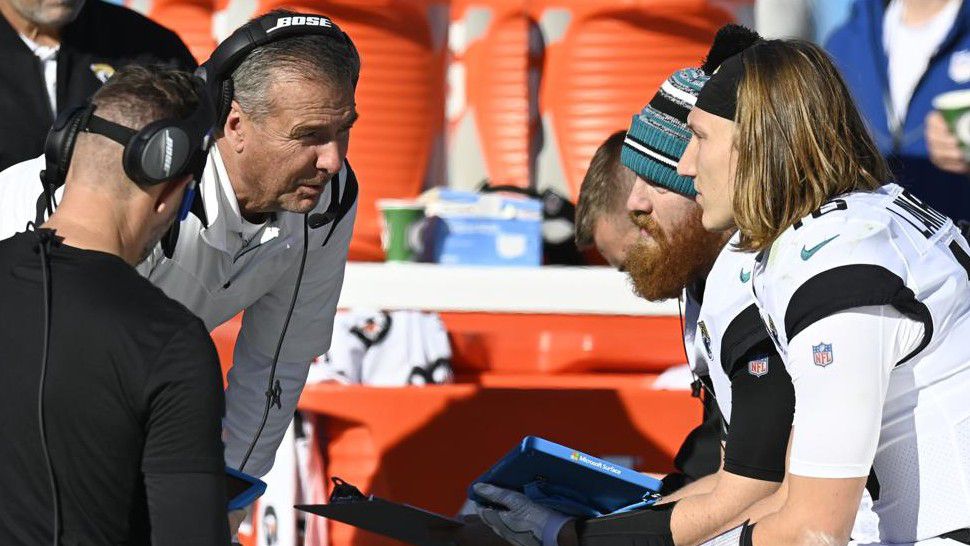 Jacksonville Jaguars head coach Urban Meyer speaks with Jacksonville Jaguars quarterback Trevor Lawrence (16) in the bench area during the first half of an NFL football game against the Tennessee Titans, Sunday, Dec. 12, 2021, in Nashville, Tenn. (AP Photo/Mark Zaleski)