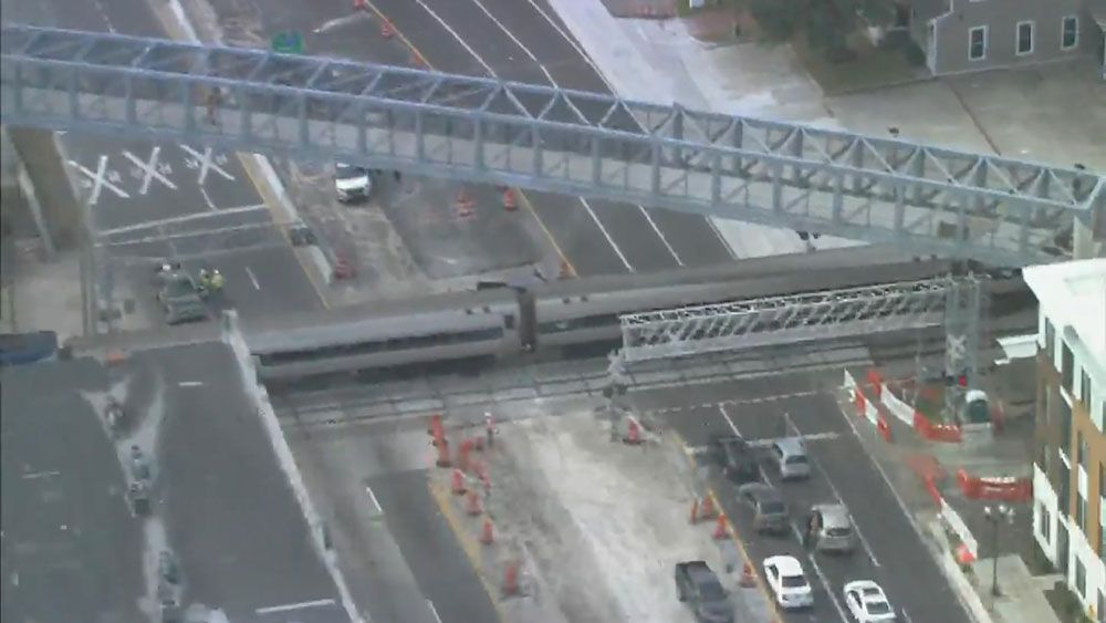 An Amtrak train across the tracks at Colonial Drive between I-4 and Orange Avenue in Orlando Thursday. (Sky 13)