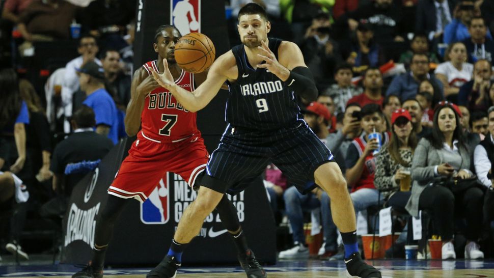 Orlando Magic's Nikola Vucevic, right, is defended by Chicago Bulls' Justin Holiday in the first half of their regular-season NBA basketball game in Mexico City, Thursday, Dec. 13, 2018. (AP Photo/Rebecca Blackwell)