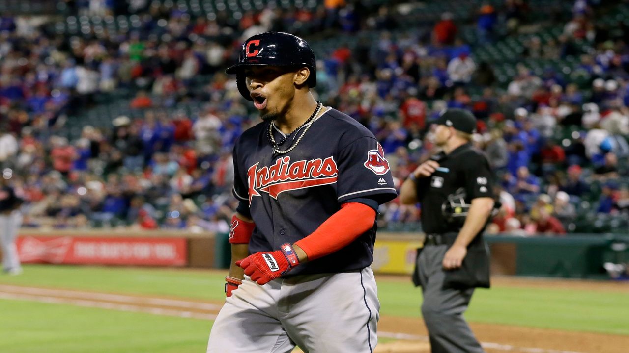 Cleveland Indians' Francisco Lindor celebrates his grand slam as he heads to the dugout in the ninth inning of a baseball game against the Texas Rangers in Arlington, Texas, Wednesday, April 5, 2017. (AP Photo/Tony Gutierrez)