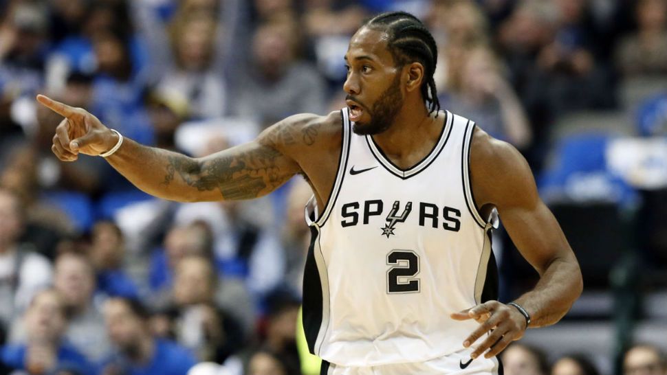 San Antonio Spurs forward Kawhi Leonard (2) celebrates sinking a basket in the first half of an NBA basketball game against the Dallas Mavericks onTuesday, Dec. 12, 2017, in Dallas. (AP Photo/Tony Gutierrez)