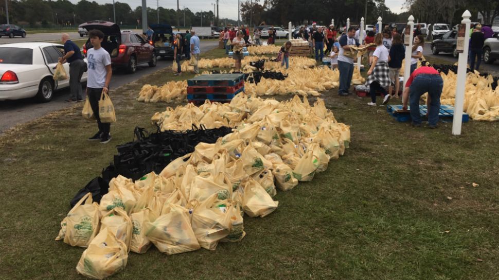 Volunteers lined the drive in front of Faith Baptist Church to load different items at different stations -- fresh produce, canned goods and more. (Sarah Blazonis/Spectrum Bay News 9)