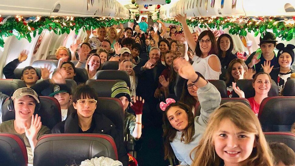 Gold Star family members wave before a charter flight from Los Angeles to Orlando on Saturday, courtesy of the Gary Sinise Foundation. (@GarySinise on Twitter)