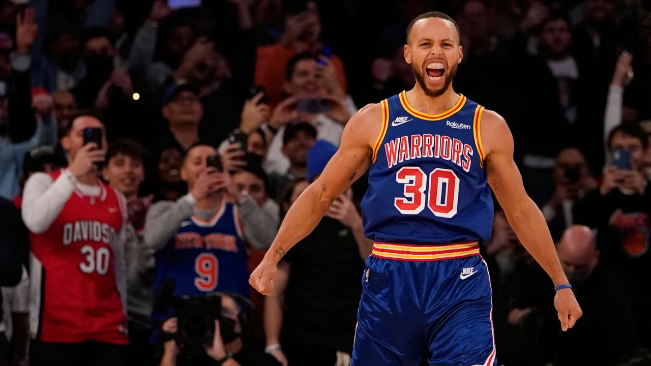 Golden State Warriors guard Stephen Curry reacts after scoring a 3-point basket during the first half of an NBA basketball game against the New York Knicks, Tuesday, Dec. 14, 2021, at Madison Square Garden in New York. (AP Photo/Mary Altaffer)