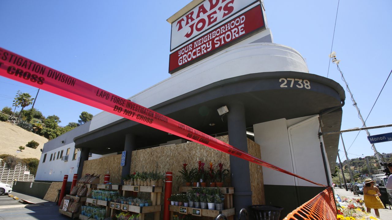 Red tape blocks access to a Trader Joe's grocery store in the Los Feliz neighborhood of Los Angeles, Sunday, July 22, 2018. (AP/Damian Dovarganes)