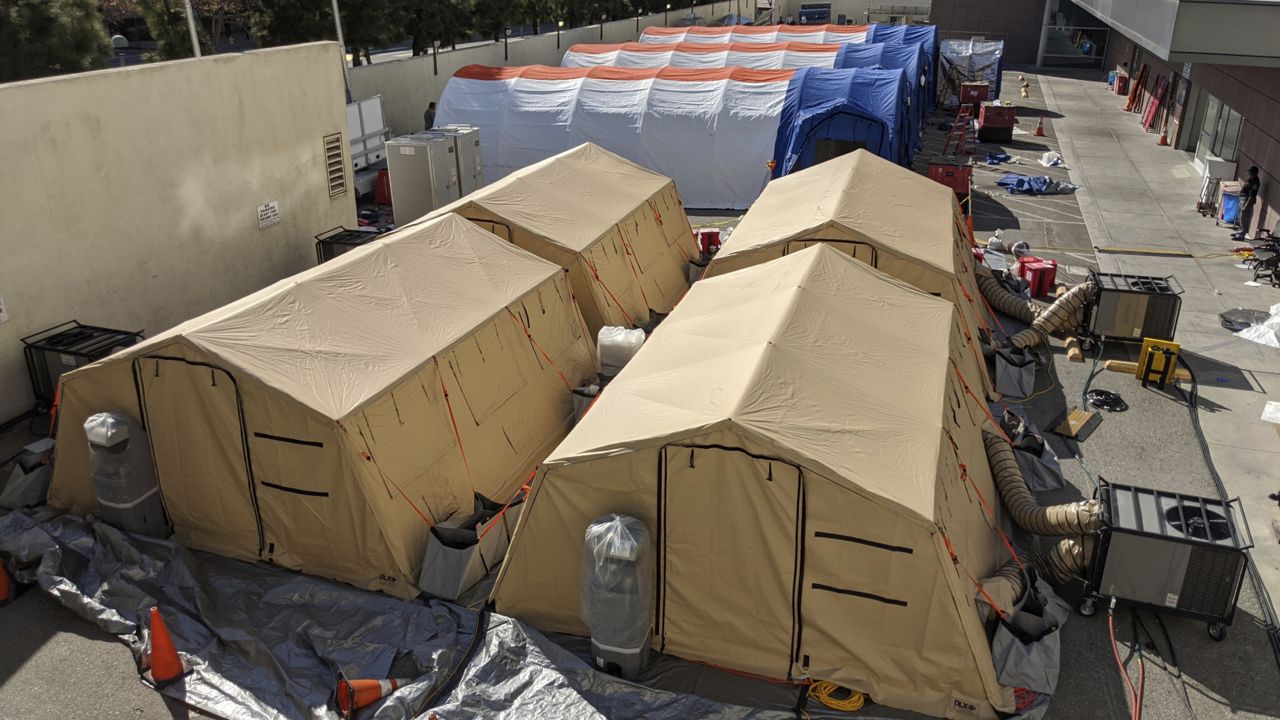 Triage tents are deployed for a possible surge of emergency COVID-19 patients outside of the Los Angeles County + USC Medical Center in Los Angeles on March 30, 2020. (AP Photo/Damian Dovarganes)