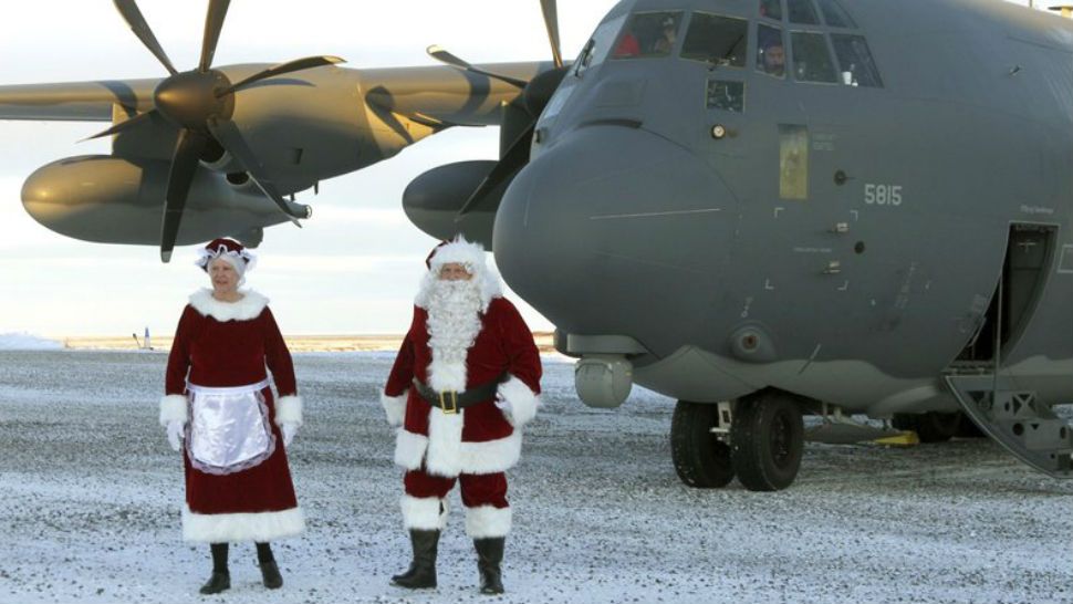 Mr. and Mrs. Santa Claus, travelling with Operation Santa Claus, de-board an HC-130J Combat King II from the 211th Rescue Squadron, Alaska Air National Guard, after landing in St. Michael, Alaska, on Dec. 5, 2017. Operation Santa Claus is an Alaska National Guard annual community outreach program that provides Christmas gifts, books, backpacks filled with school supplies, fresh fruit and sundaes to youngsters in rural communities. (Photo Credit: U.S. Army photo by 2nd Lt. Marisa Lindsay)