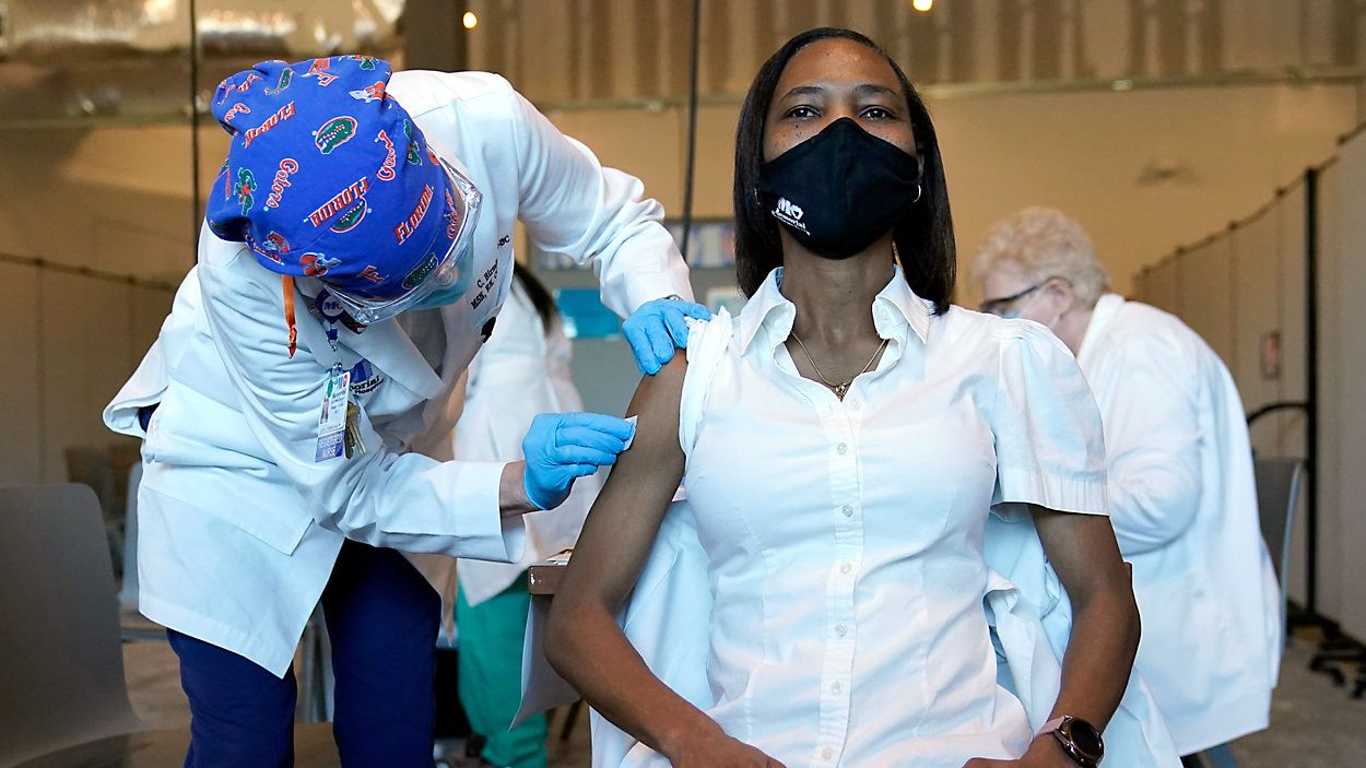 Registered nurse La Tanya Forbes waits to be inoculated with the Pfizer-BioNTech COVID-19 vaccine by registered nurse Cheryl Birmingham on Monday, December 14, 2020 at Memorial Healthcare System in Miramar, Florida. (Lynne Sladky/AP)