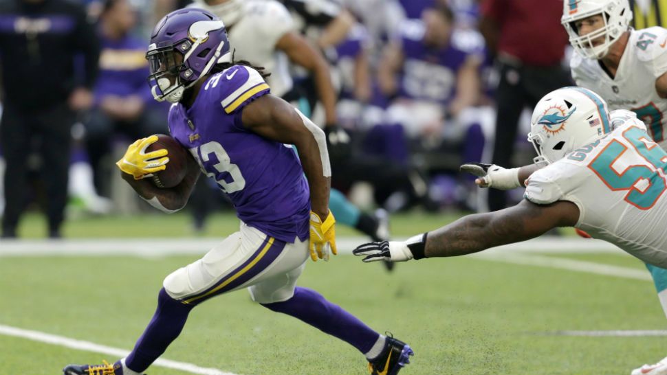 Minnesota Vikings running back Dalvin Cook (33) runs from Miami Dolphins outside linebacker Jerome Baker during the first half of an NFL football game, Sunday, Dec. 16, 2018, in Minneapolis. (AP Photo/Andy Clayton-King)