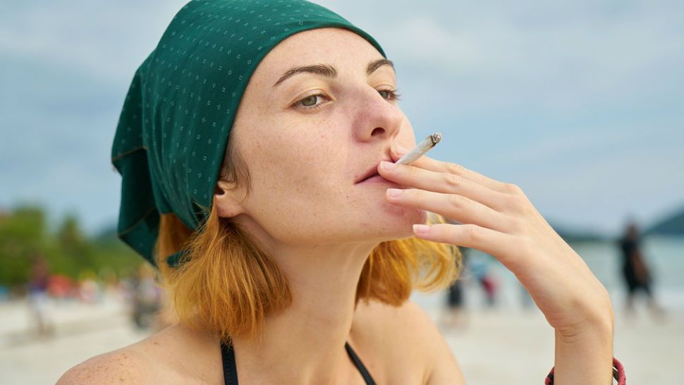 Woman smokes joint. 