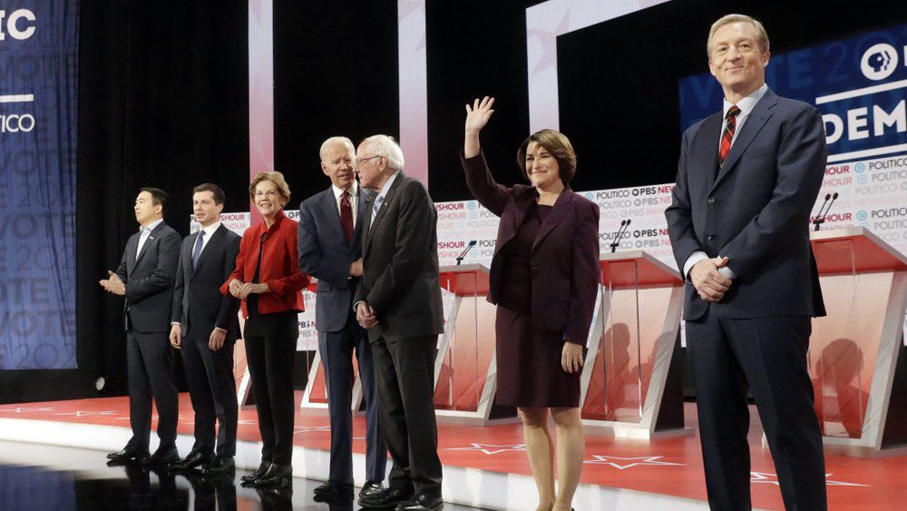 Democratic presidential candidates from left, entrepreneur Andrew Yang, South Bend Mayor Pete Buttigieg, Sen. Elizabeth Warren, D-Mass., former Vice President Joe Biden, Sen. Bernie Sanders, I-Vt., Sen. Amy Klobuchar, D-Minn., and businessman Tom Steyer stand on stage before a Democratic presidential primary debate Thursday, Dec. 19, 2019, in Los Angeles, Calif. (AP Photo/Chris Carlson)