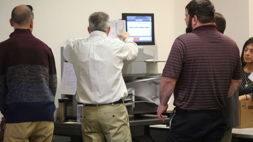 Officials will use a high-speed machine on to recount results from the 94th District House of Delegates race at City Center in Newport News, Va. on Tuesday, Dec. 19, 2017. Incumbent Republican Del. David Yancey won by 10 votes. Democratic challenger Shelly Simonds requested the recount.(Joe Fudge/The Daily Press via AP)