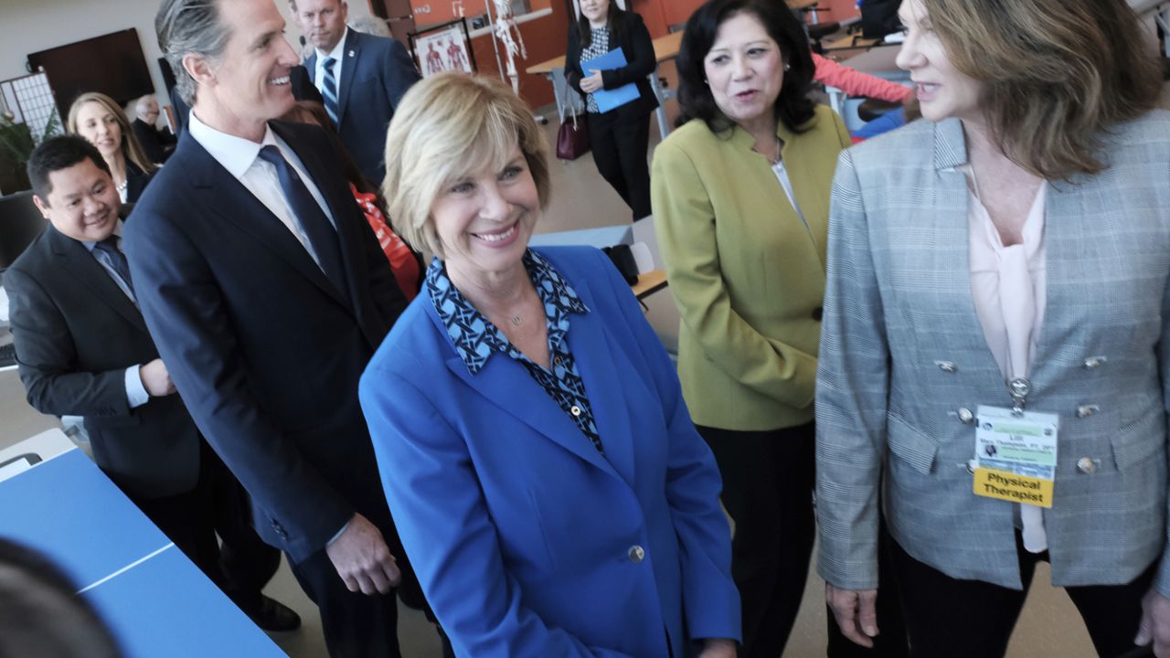 L.A. County Board of Supervisors Janice Hahn, center, California Gov. Gavin Newsom, left and L.A. County Supervisor Hilda Solis, second from right, take a tour of the Rancho Los Amigos National Rehabilitation Center in Downey, Calif. on April 17, 2019. (AP/Richard Vogel)