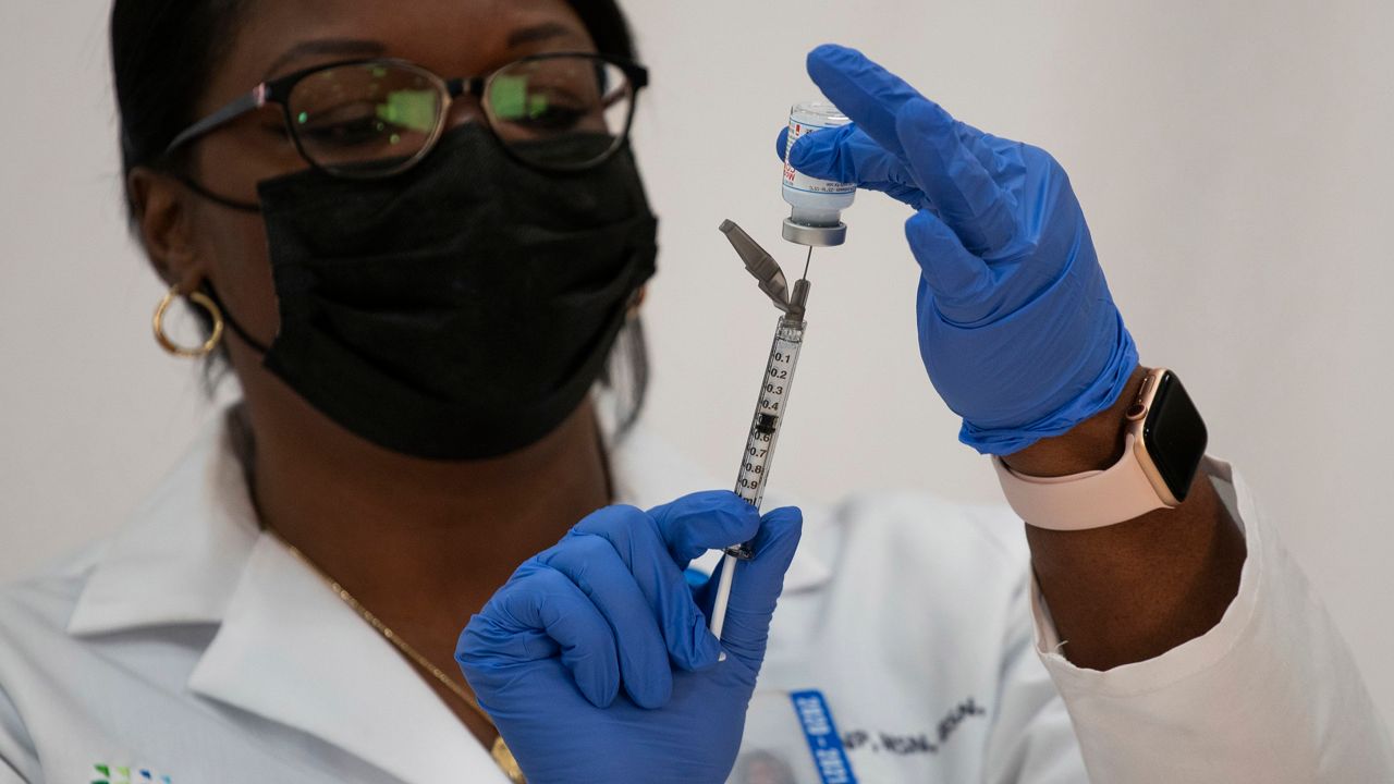 New York City firefighter emergency medical services personnel are vaccinated against COVID-19 at the FDNY Fire Academy in New York, Wednesday, Dec. 23, 2020.