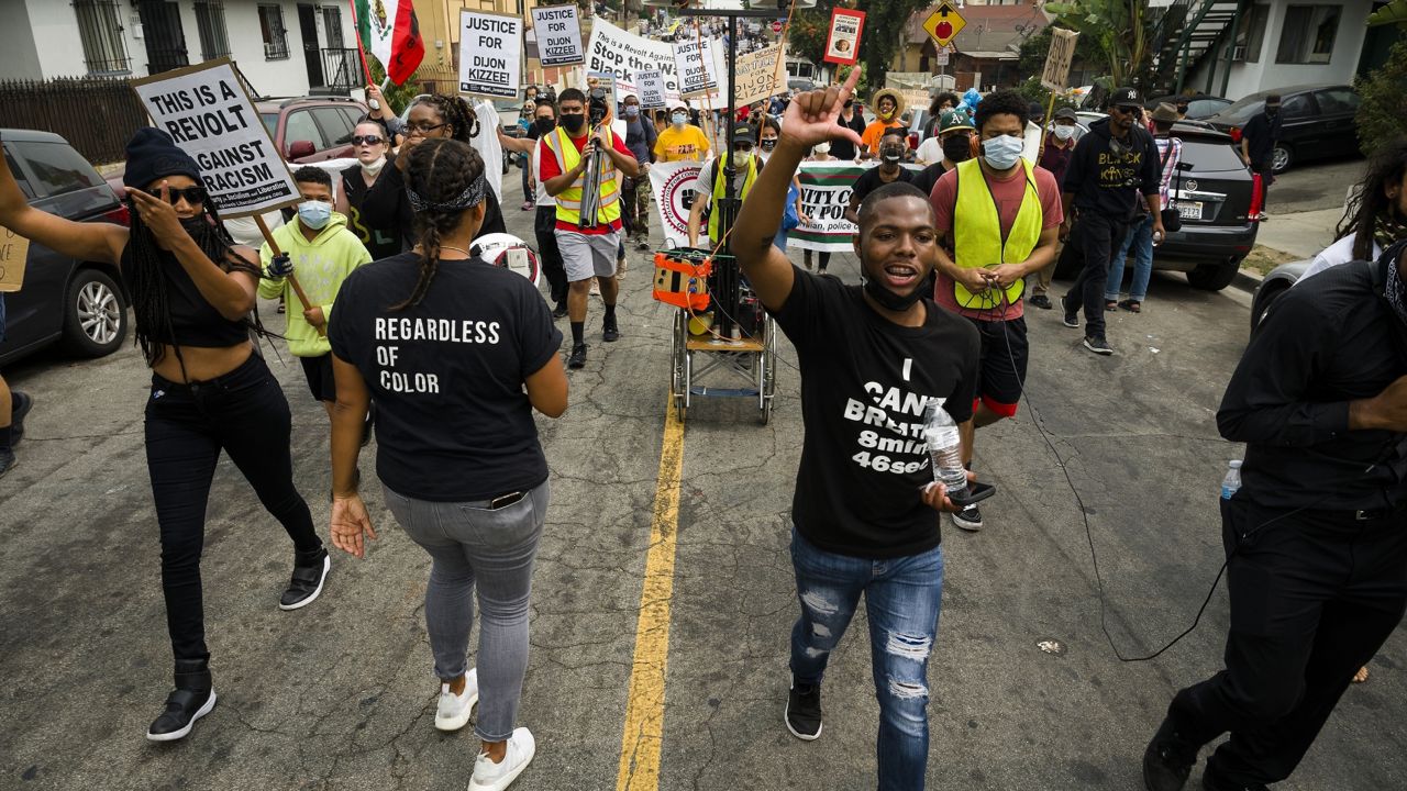 Protesters march across residential neighborhoods of South Los Angeles during a demonstration condemning the Los Angeles County Sheriff's killing of Dijon Kizzee, Saturday, Sept. 12, 2020 in Los Angeles. (AP Photo/Jintak Han)