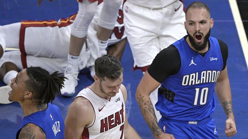 Orlando Magic guards Markelle Fultz (20) and Evan Fournier (10) celebrate after Fournier was fouled while scoring a basket, as Miami Heat guard Goran Dragic (7) walks away during the second half of an NBA basketball game, Wednesday, Dec. 23, 2020, in Orlando, Fla. (AP Photo/Phelan M. Ebenhack)