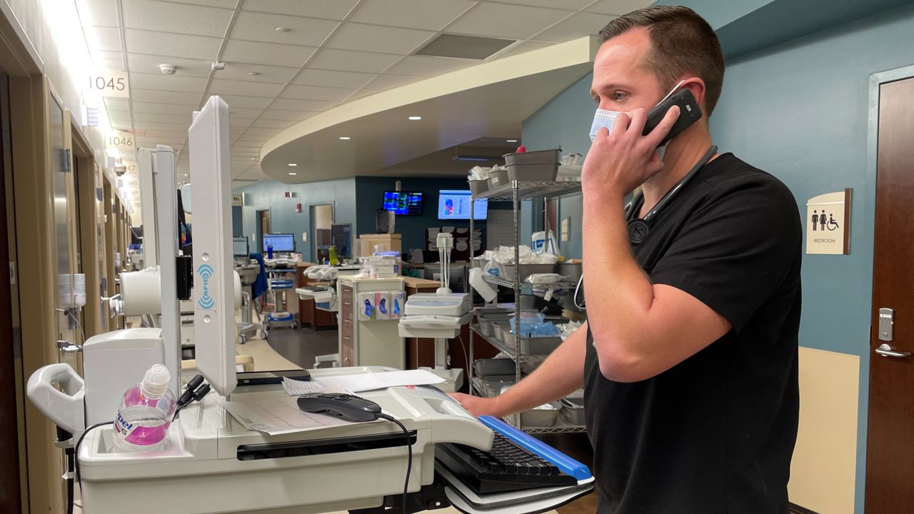 Dr. Michael Patch tends to patients in the emergency room at AdventHealth Wesley Chapel on December 21, 2021. (Sarah Blazonis/Spectrum Bay News 9)